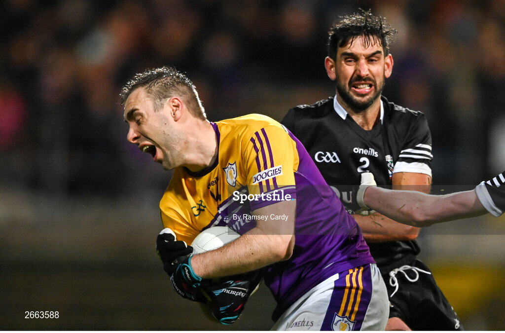 5 November 2023; Conall Jones of Derrygonnelly Harps is tackled by Niall Branagan of Kilcoo during the AIB Ulster GAA Football Senior Club Championship round 1 match between Derrygonnelly Harps of Fermanagh and Kilcoo of Down at Brewster Park in Enniskillen, Fermanagh. Photo by Ramsey Cardy/Sportsfile