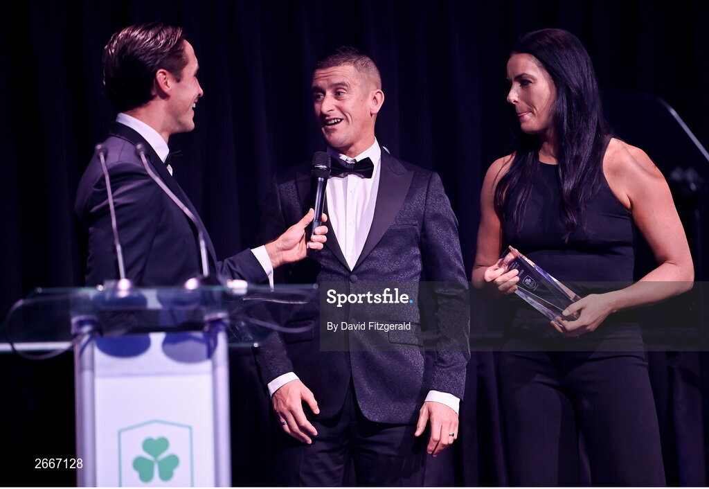 11 November 2023; Olympians Rob and Marian Heffernan are interviewd by MC Greg O'Shea after being presented with the Flogas Community Ambassador of the year award at the Team Ireland Olympic Ball at the Mansion House in Dublin. The event was a joint celebration of the brilliant performances of Team Ireland athletes at the European Games this summer, as well as the announcement of the winners of the Olympic Federation of Ireland Annual Awards. The event was attended by the Minister for Tourism, Culture, Arts, Gaeltacht, Sport and Media, Catherine Martin TD, Minister of State for Sport and Physical Education, Thomas Byrne TD, Olympic medallists, European Games athletes, Team Ireland Sponsors and Partners, Sport Ireland and the wider Olympic family. Photo by David Fitzgerald/Sportsfile