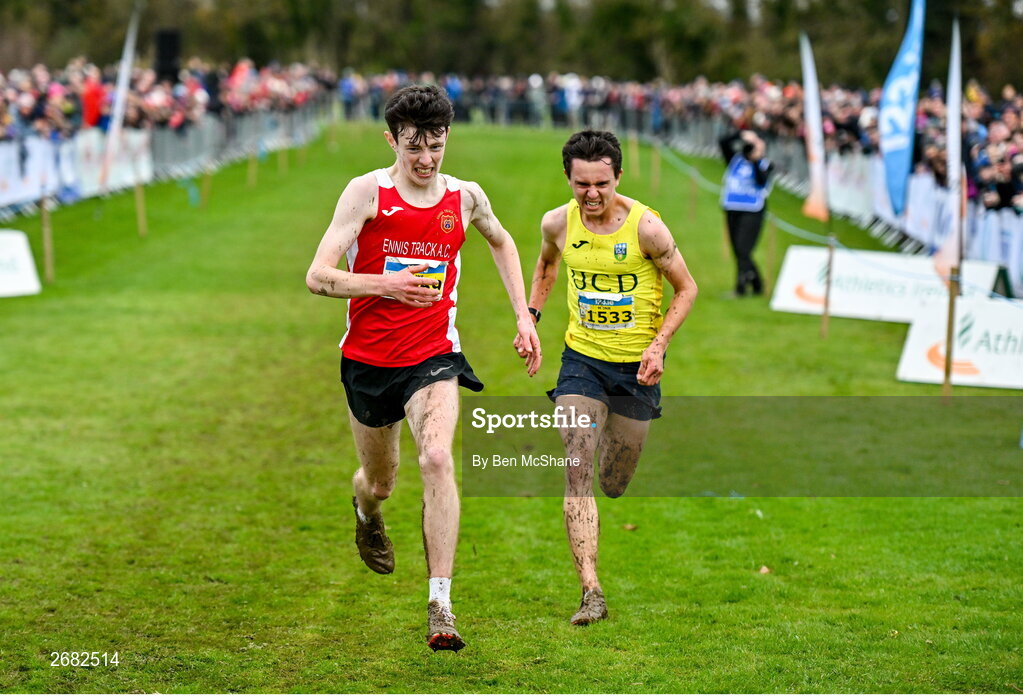 19 November 2023; Niall Murphy of Ennis Track AC, Clare, left, and Jonas Stafford of UCD AC, Dublin, race for the finish line in the Mens U18 & Junior 5000m during the 123.ie National Senior & Even Age Cross Country Championships at Gowran Demesne in Kilkenny. Photo by Ben McShane/Sportsfile
