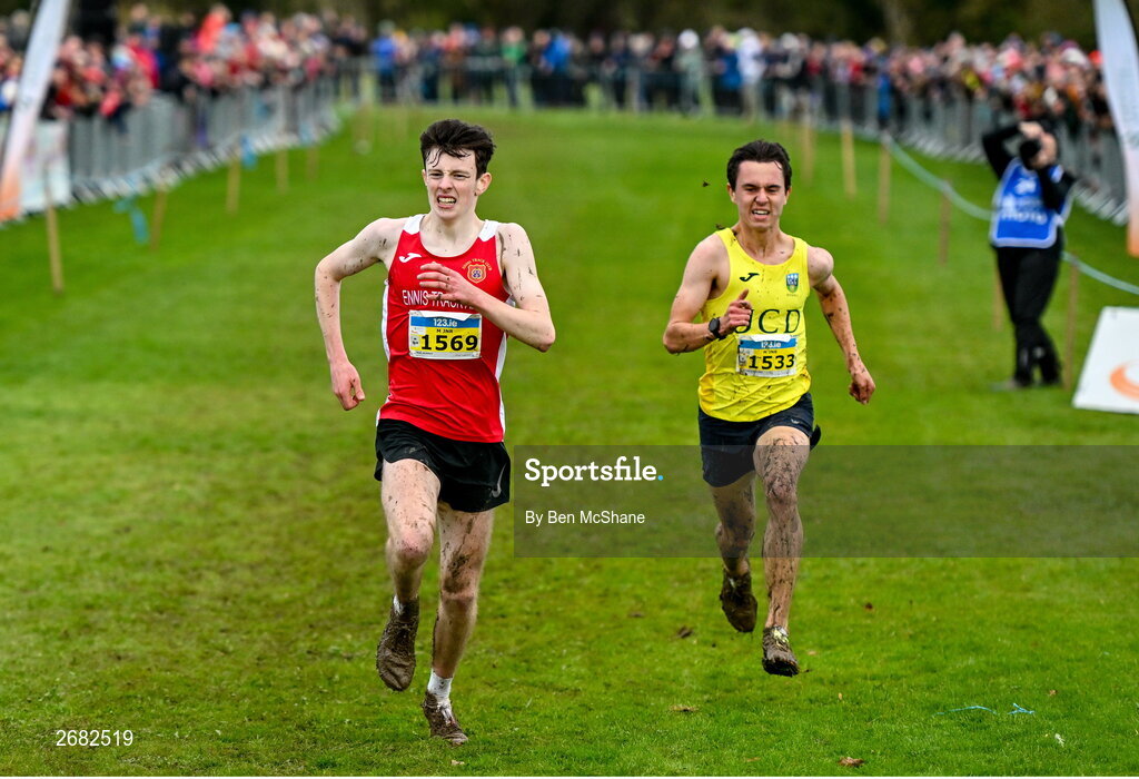 19 November 2023; Niall Murphy of Ennis Track AC, Clare, left, and Jonas Stafford of UCD AC, Dublin, race for the finish line in the Mens U18 & Junior 5000m during the 123.ie National Senior & Even Age Cross Country Championships at Gowran Demesne in Kilkenny. Photo by Ben McShane/Sportsfile
