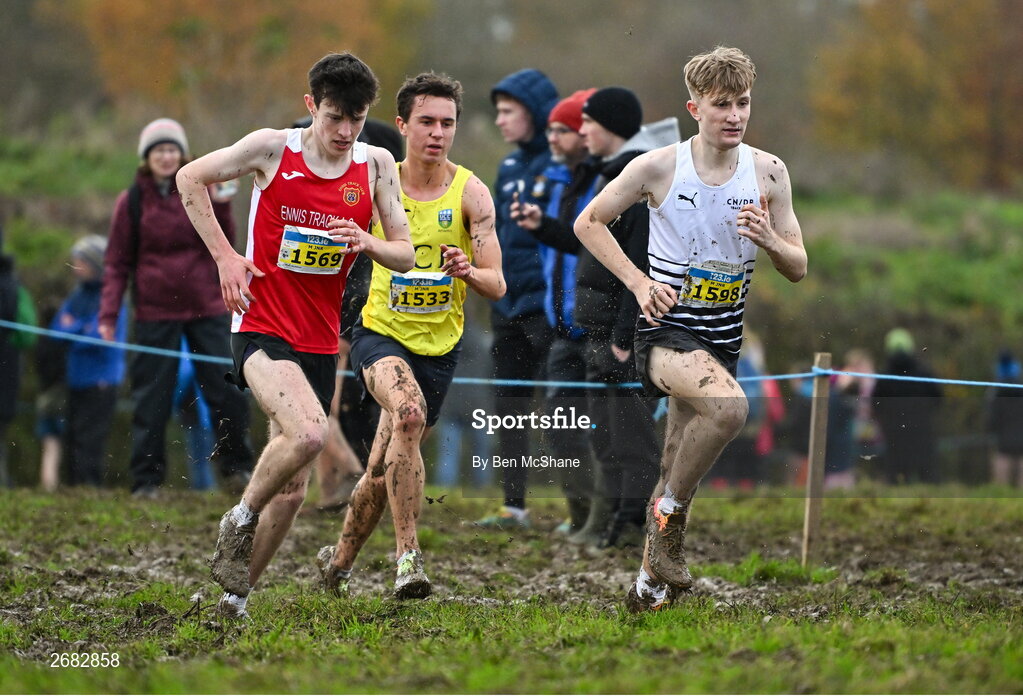 19 November 2023; Competitors, from left, Niall Murphy of Ennis Track AC, Clare, Jonas Stafford of UCD AC, Dublin, and Nick Griggs of CNDR Track Club AC, Antrim, compete in the Mens U18 & Junior 5000m during the 123.ie National Senior & Even Age Cross Country Championships at Gowran Demesne in Kilkenny. Photo by Ben McShane/Sportsfile