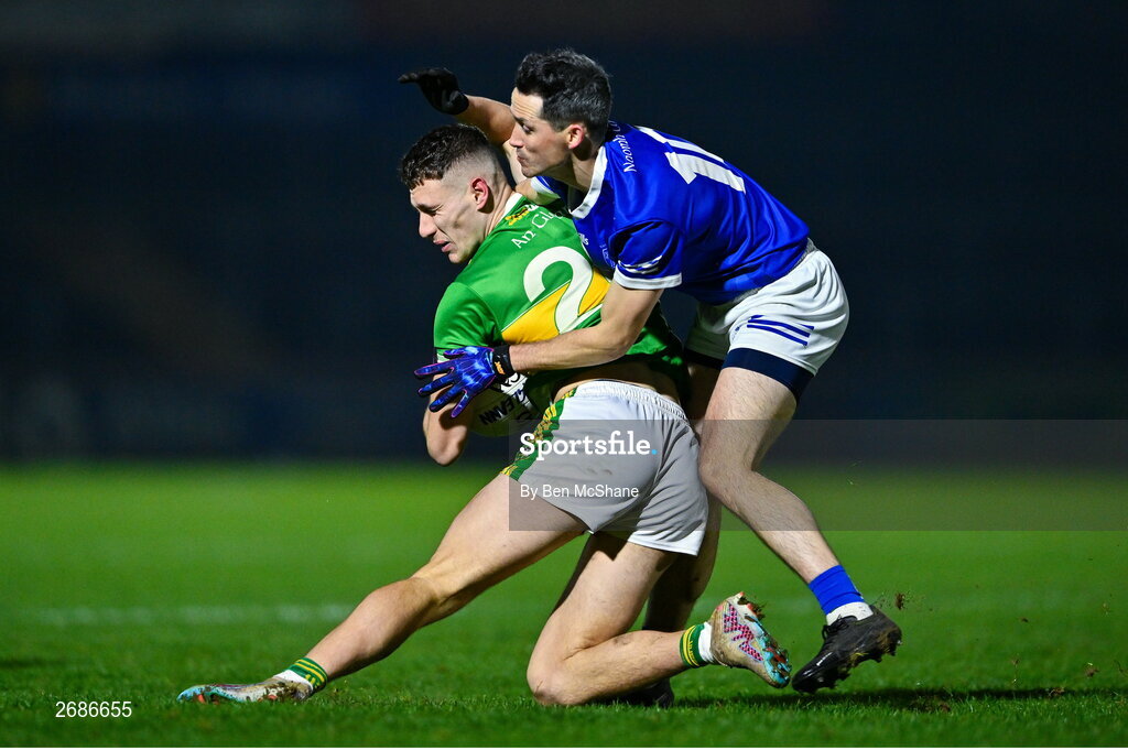 25 November 2023; Jody McDermott of Glen is tackled by Brendan McDyer of Naomh Conaill during the AIB Ulster GAA Football Senior Club Championship semi-final match between Glen, Derry, and Naomh Conaill, Donegal, at Healy Park in Omagh, Tyrone. Photo by Ben McShane/Sportsfile