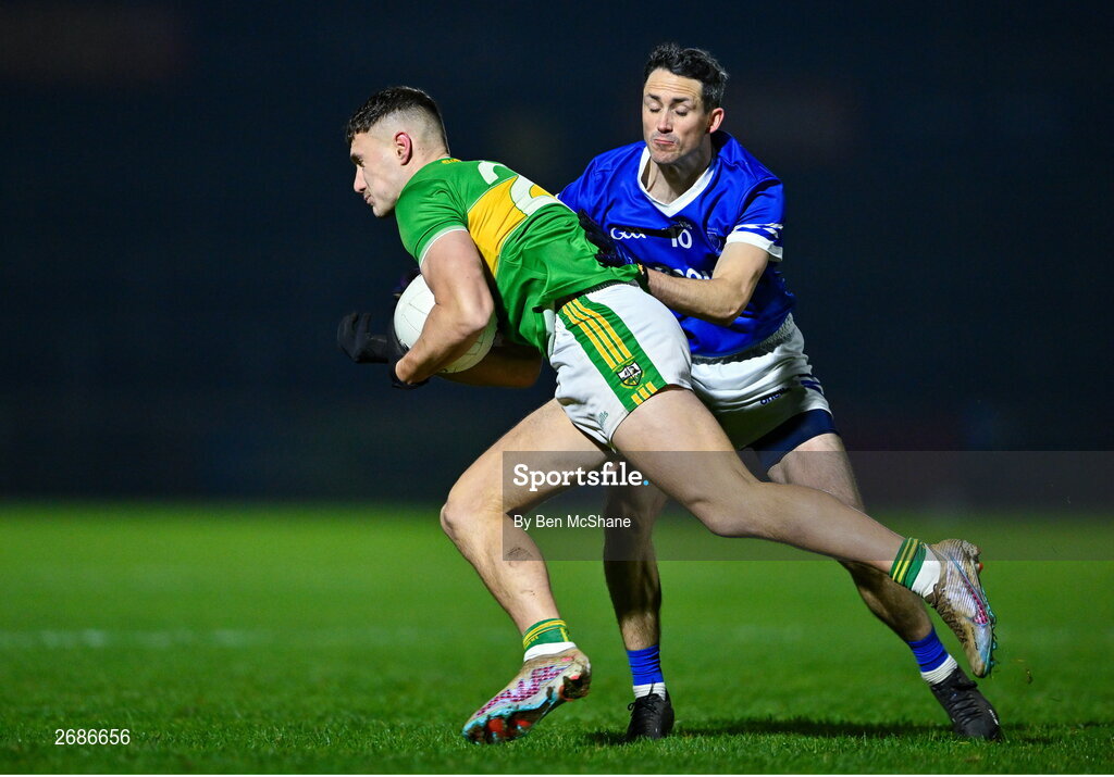 25 November 2023; Jody McDermott of Glen is tackled by Brendan McDyer of Naomh Conaill during the AIB Ulster GAA Football Senior Club Championship semi-final match between Glen, Derry, and Naomh Conaill, Donegal, at Healy Park in Omagh, Tyrone. Photo by Ben McShane/Sportsfile