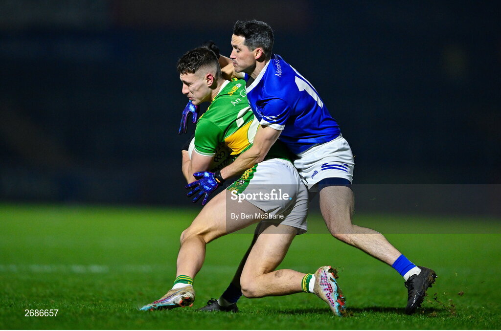 25 November 2023; Jody McDermott of Glen is tackled by Brendan McDyer of Naomh Conaill during the AIB Ulster GAA Football Senior Club Championship semi-final match between Glen, Derry, and Naomh Conaill, Donegal, at Healy Park in Omagh, Tyrone. Photo by Ben McShane/Sportsfile