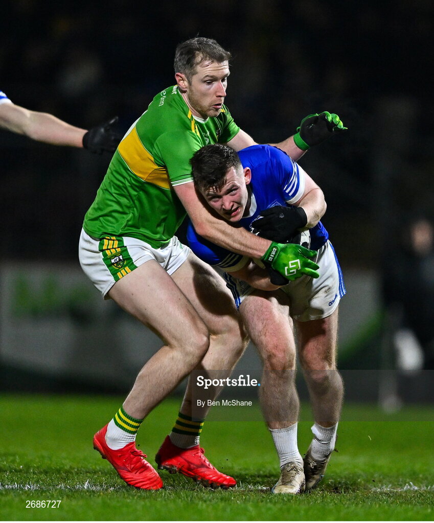 25 November 2023; Jeaic Mac Ceallbhuí of Naomh Conaill is tackled by Emmett Bradley of Glen during the AIB Ulster GAA Football Senior Club Championship semi-final match between Glen, Derry, and Naomh Conaill, Donegal, at Healy Park in Omagh, Tyrone. Photo by Ben McShane/Sportsfile