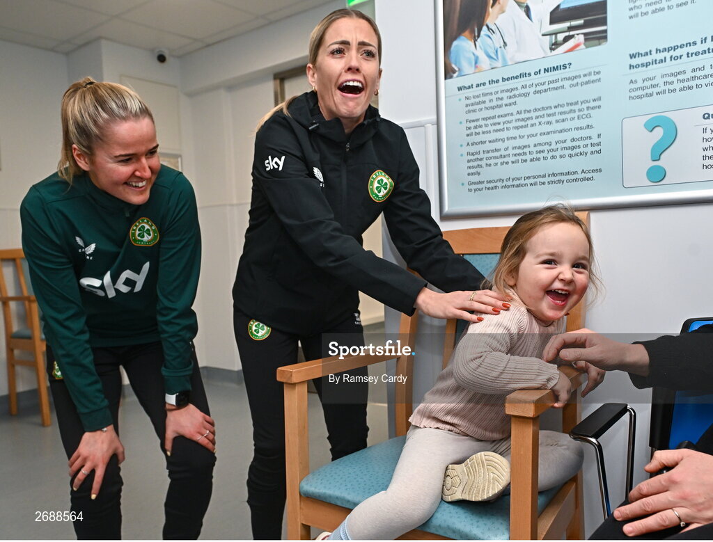 27 Novmeber 2023; Republic of Ireland's Erin McLaughlin, left, and Denise O'Sullivan, with Duvheasa Finneran, age 2, from Toberconor, Roscommon, during a visit to Cappagh Kids and The National Orthopaedic Hospital Cappagh in Dublin to launch the Cappagh Hospital Foundation Christmas Appeal and their fundraising ambassador Boney Maloney. Photo by Ramsey Cardy/Sportsfile