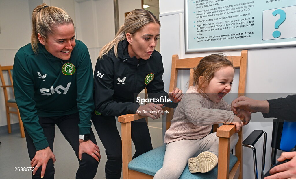 27 Novmeber 2023; Republic of Ireland's Erin McLaughlin, left, and Denise O'Sullivan, with Duvheasa Finneran, age 2, from Toberconor, Roscommon, during a visit to Cappagh Kids and The National Orthopaedic Hospital Cappagh in Dublin to launch the Cappagh Hospital Foundation Christmas Appeal and their fundraising ambassador Boney Maloney. Photo by Ramsey Cardy/Sportsfile