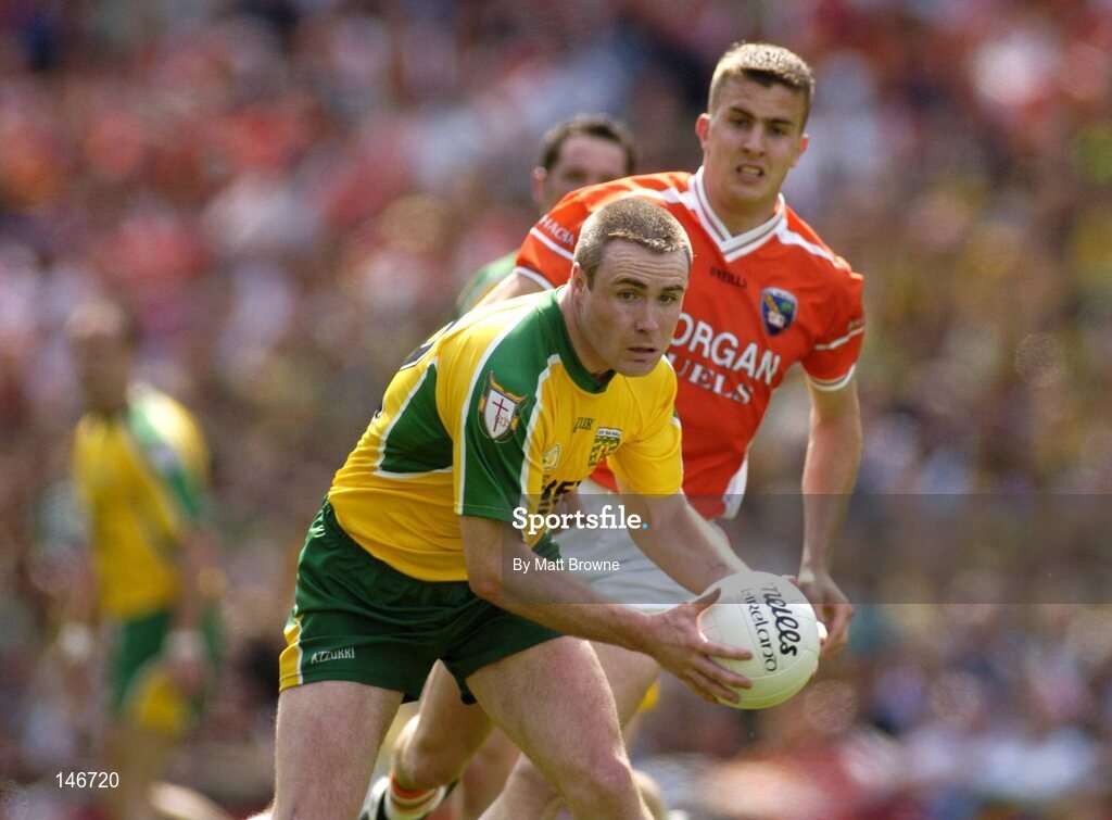 11 July 2004; John Gildea, Donegal, prepares to clear under pressure from Philip Loughran, Armagh. Bank of Ireland Ulster Senior Football Championship Final, Armagh v Donegal, Croke Park, Dublin. Picture credit; Matt Browne / SPORTSFILE