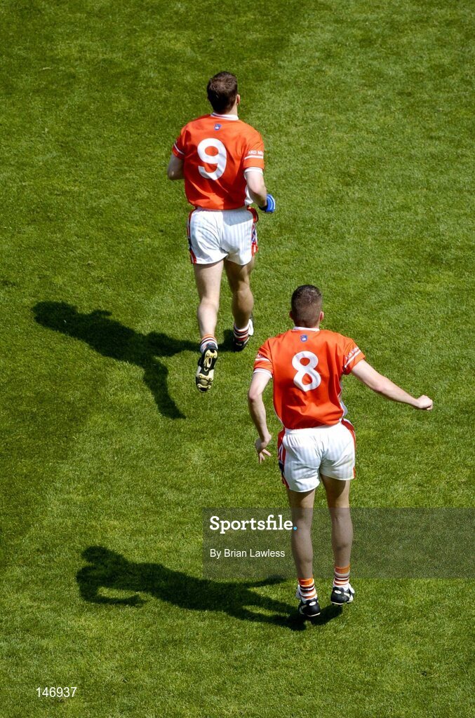 11 July 2004; Armagh's Paul McGrane (9) and Philip Loughran make their way onto the pitch for the second half. Bank of Ireland Ulster Senior Football Championship Final, Armagh v Donegal, Croke Park, Dublin. Picture credit; Brian Lawless / SPORTSFILE