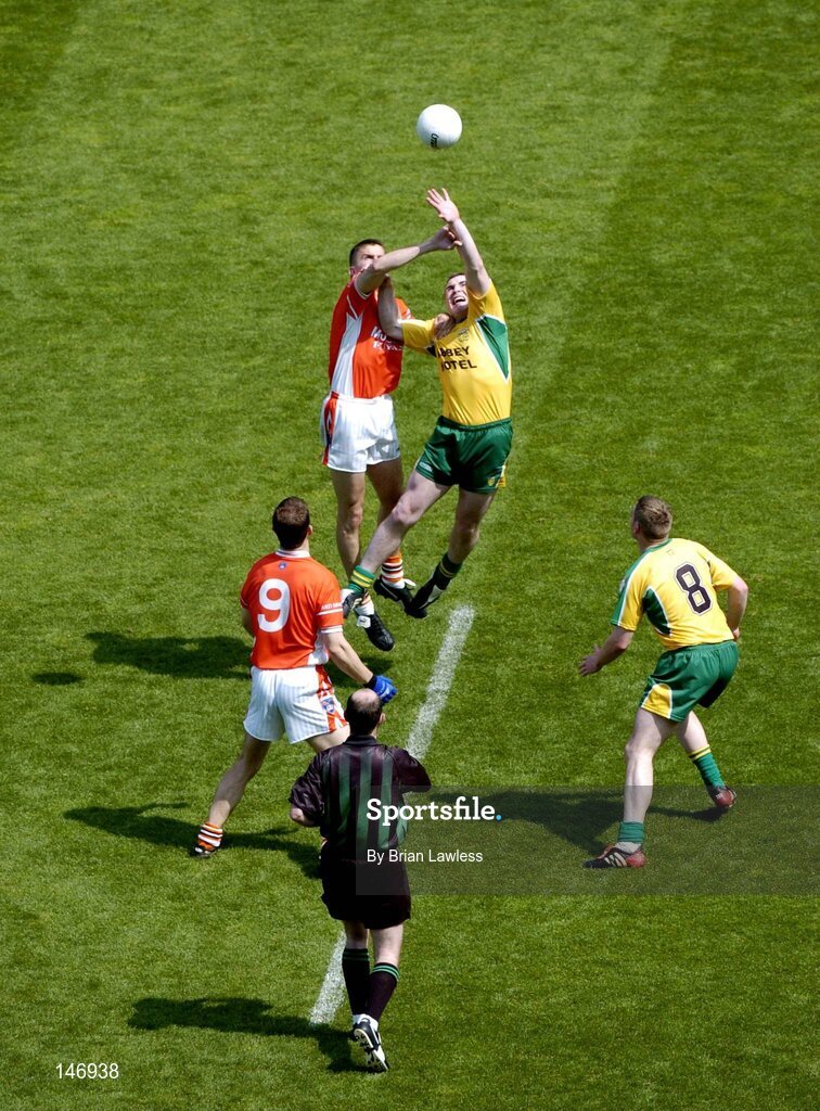 11 July 2004; Donegal's John Gildea and Armagh's Paul McGrane, contest the throw in for the second half as Armagh's Philip Loughran (9) and Donegal's Stephen McDermott (8) await the breaking ball while referee Michael Collins looks on. Bank of Ireland Ulster Senior Football Championship Final, Armagh v Donegal, Croke Park, Dublin. Picture credit; Brian Lawless / SPORTSFILE