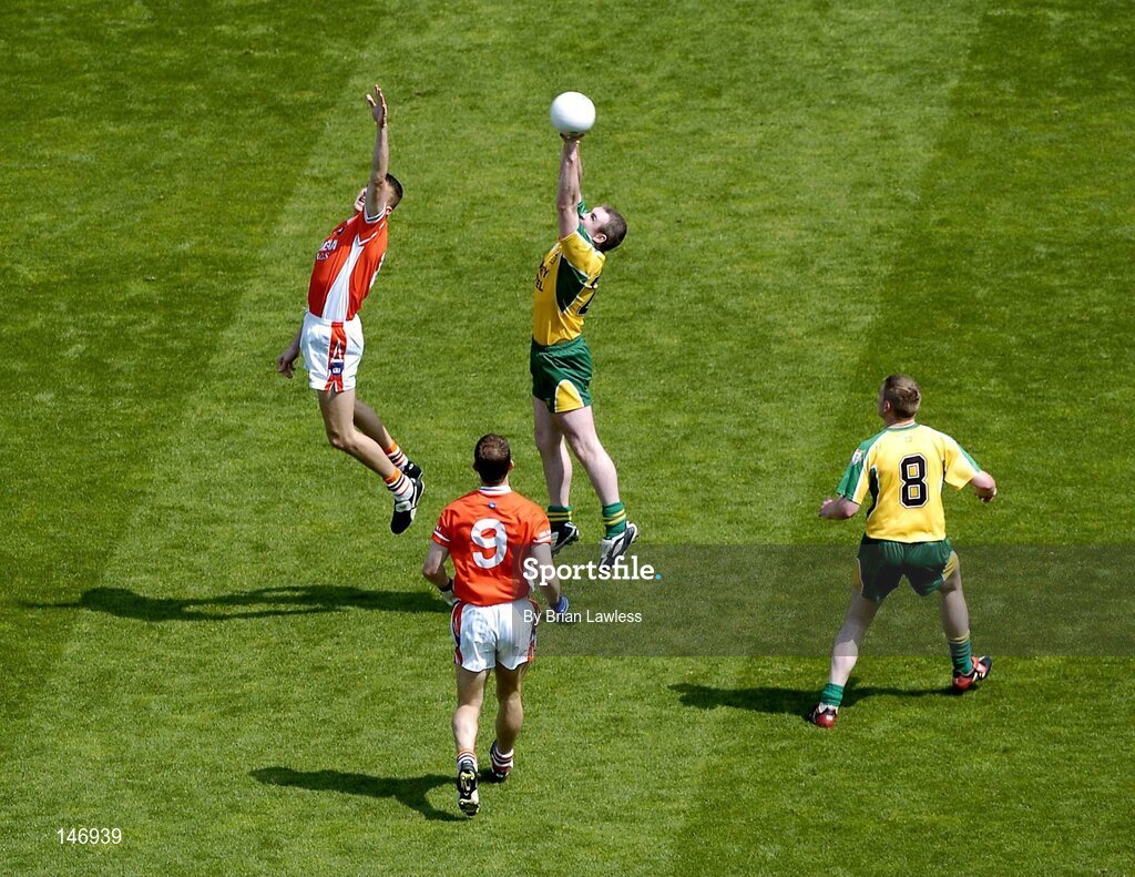 11 July 2004; Donegal's John Gildea wins the ball ahead of Armagh's Philip Loughran, as Armagh's Paul McGrane (9) and Donegal's Brendan Boyle look on. Bank of Ireland Ulster Senior Football Championship Final, Armagh v Donegal, Croke Park, Dublin. Picture credit; Brian Lawless / SPORTSFILE