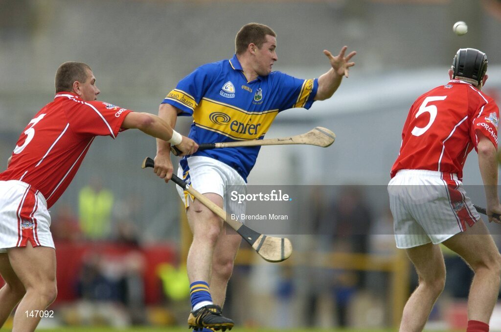 10 July 2004; John Carroll, Tipperary, in action against Diarmuid O'Sullivan (3) and John Gardiner, Cork. Guinness Senior Hurling Championship Qualifier, Round 3, Cork v Tipperary, Fitzgerald Stadium, Killarney, Co. Kerry. Picture credit; Brendan Moran / SPORTSFILE