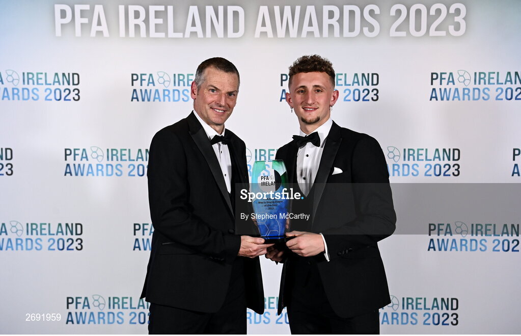 2 December 2023; Sam Curtis of St Patrick's Athletic is presented with the PFA Ireland Men’s Young Player of the Year award by Republic of Ireland U21 manager Jim Crawford during the PFA Ireland Awards 2023 at Anantara The Marker Dublin Hotel in Dublin. Photo by Stephen McCarthy/Sportsfile