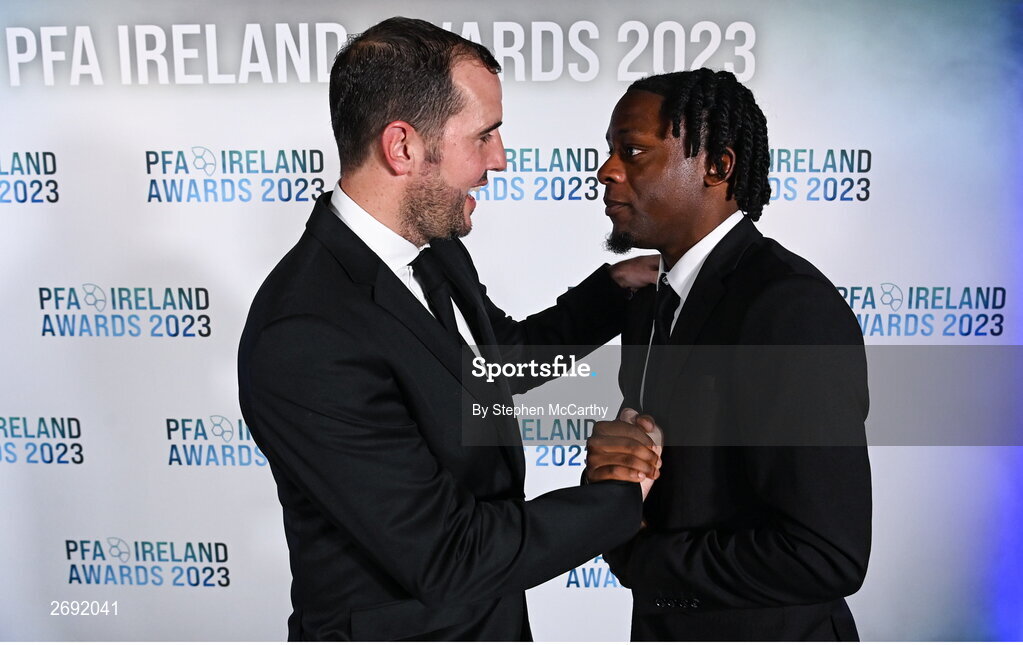 2 December 2023; PFA Ireland Men’s Premier Division Team of the Year 2023 medal recipient Jonathan Afolabi of Bohemians is congratulated by guest of honour John O'Shea, former Republic of Ireland international, during the PFA Ireland Awards 2023 at Anantara The Marker Dublin Hotel in Dublin. Photo by Stephen McCarthy/Sportsfile