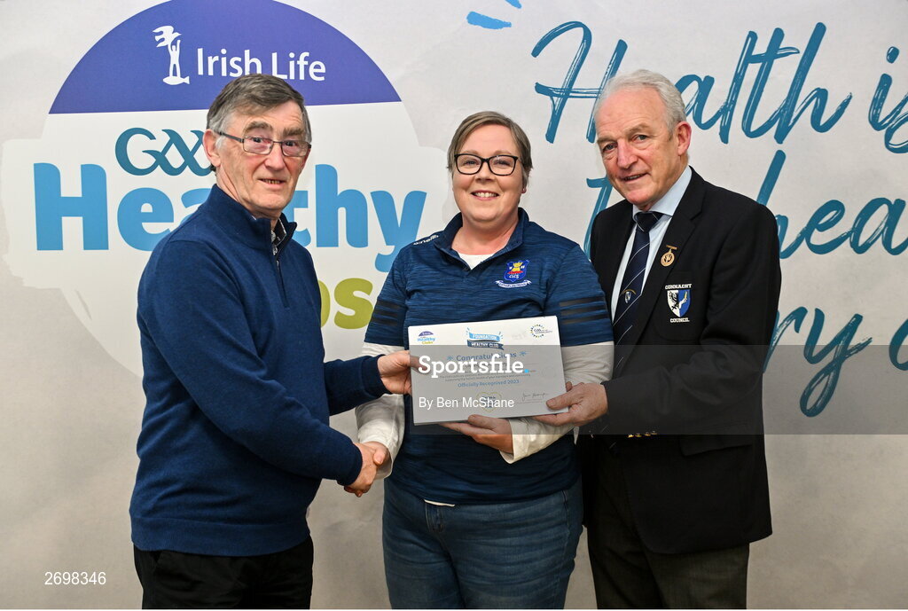 14 December 2023; Caherlistrane, Galway, representative Claire Kane is presented their Foundation Healthy Club award by Connacht GAA secretary John Prenty, left, and Connacht GAA Council president John Murphy, right, during the Irish Life Connacht GAA Healthy Clubs recognition event at the Connacht GAA Centre of Excellence in Bekan, Mayo. Photo by Ben McShane/Sportsfile