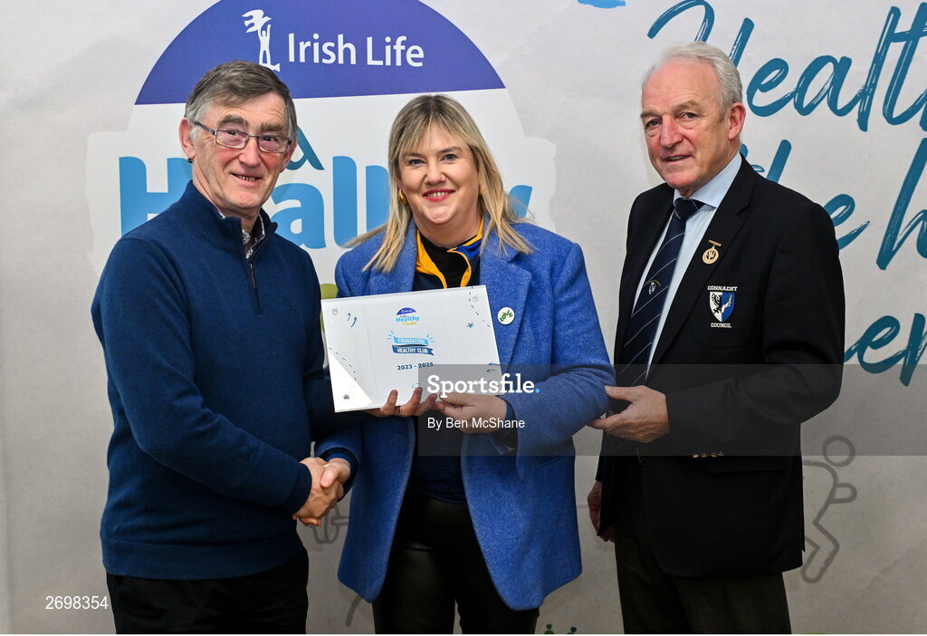 14 December 2023; Club Iomanaiocht, Galway, representative Siobhan McDonagh is presented their Foundation Healthy Club award by Connacht GAA secretary John Prenty, left, and Connacht GAA Council president John Murphy, right, during the Irish Life Connacht GAA Healthy Clubs recognition event at the Connacht GAA Centre of Excellence in Bekan, Mayo. Photo by Ben McShane/Sportsfile