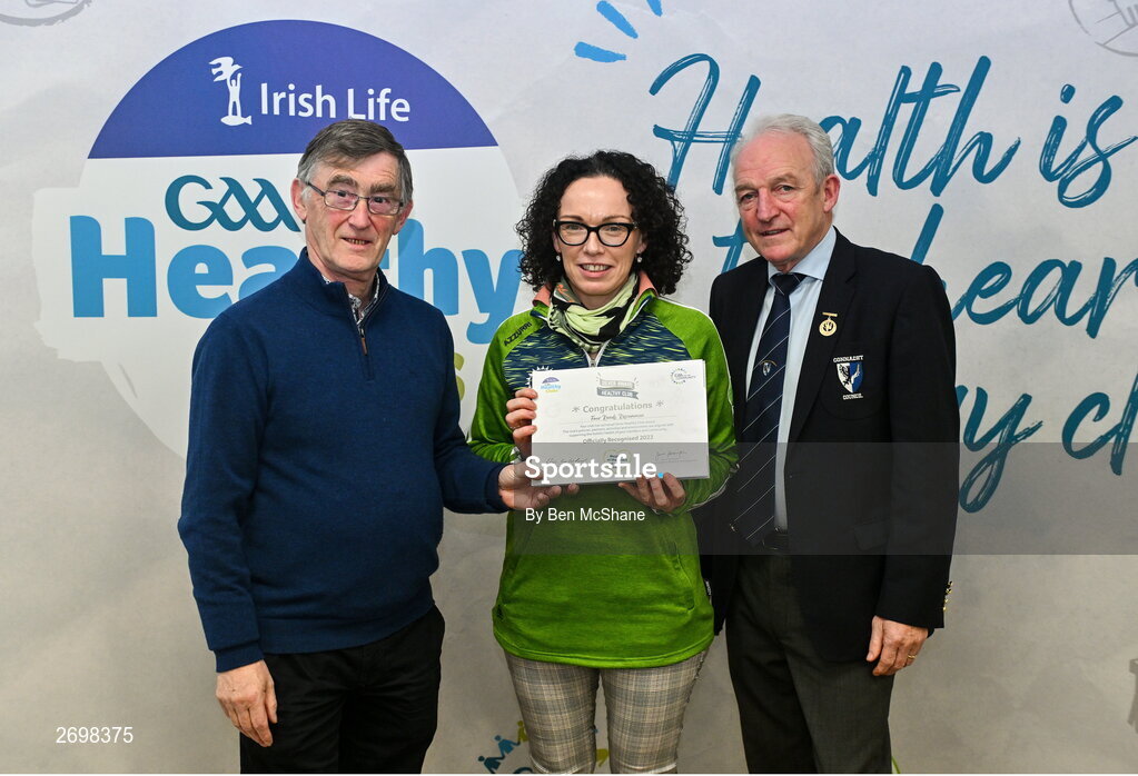 14 December 2023; Four Roads, Roscommon, representative Valerie Hynes is presented their Silver Healthy Club award by Connacht GAA secretary John Prenty, left, and Connacht GAA Council president John Murphy, right, during the Irish Life Connacht GAA Healthy Clubs recognition event at the Connacht GAA Centre of Excellence in Bekan, Mayo. Photo by Ben McShane/Sportsfile