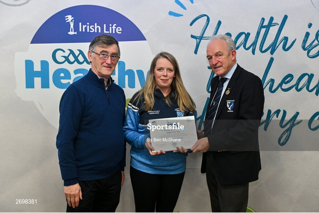 14 December 2023; Wesport, Mayo, representative Kim Robertson is presented their Foundation Healthy Club award by Connacht GAA secretary John Prenty, left, and Connacht GAA Council president John Murphy, right, during the Irish Life Connacht GAA Healthy Clubs recognition event at the Connacht GAA Centre of Excellence in Bekan, Mayo. Photo by Ben McShane/Sportsfile