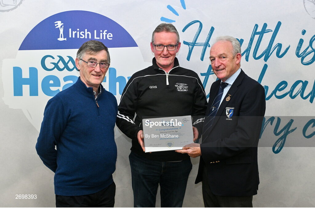 14 December 2023; Tubbercurry, Sligo, representative Patrick Lucey is presented their Foundation Healthy Club award by Connacht GAA secretary John Prenty, left, and Connacht GAA Council president John Murphy, right, during the Irish Life Connacht GAA Healthy Clubs recognition event at the Connacht GAA Centre of Excellence in Bekan, Mayo. Photo by Ben McShane/Sportsfile