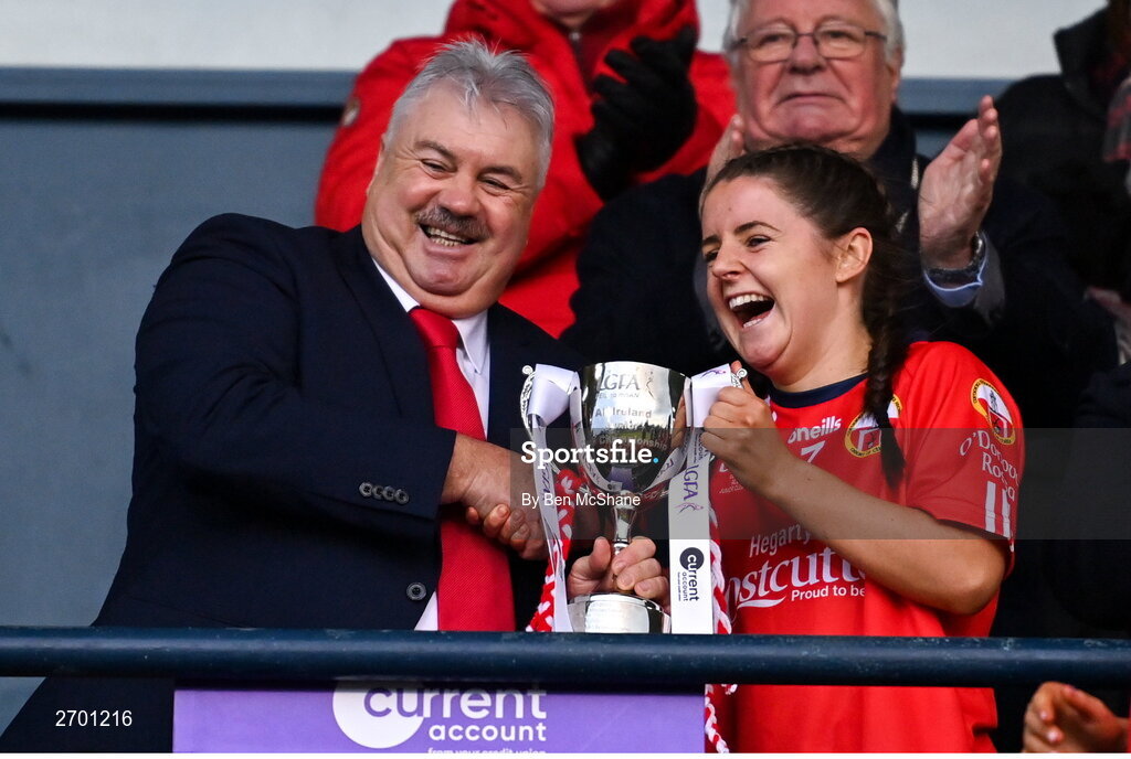 17 December 2023; O'Donovan Rossa captain Lisa Harte is presented the cup by LGFA vice-president Robbie Smyth after the Currentaccount.ie LGFA All-Ireland Junior Club Championship final match between Claremorris of Mayo and O'Donovan Rossa of Cork at Parnell Park in Dublin. Photo by Ben McShane/Sportsfile