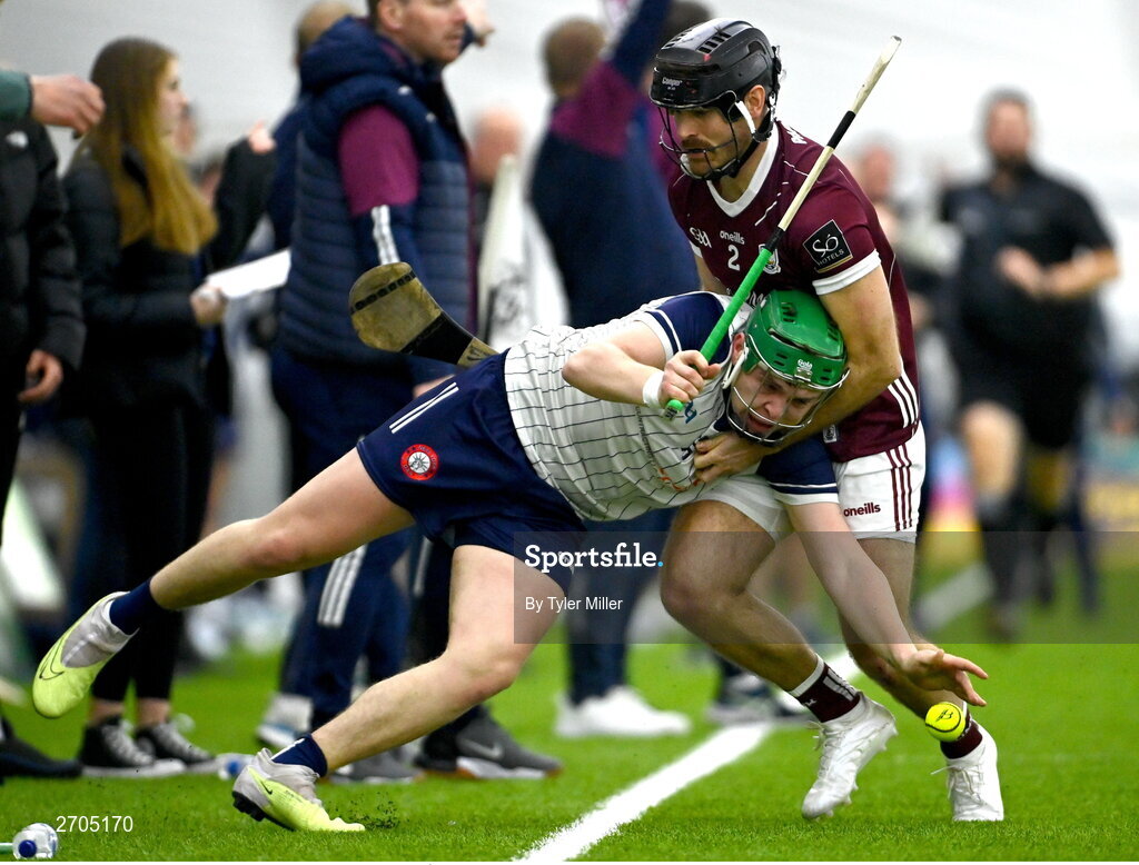 4 January 2024; Aidan Organ of New York attempts to keep the sliotar in play despite pressure from MacDara Ó'Bearra of Galway during the Connacht Hurling League semi-final match between Galway and New York at University of Galway Connacht GAA AirDome in Bekan, Mayo. Photo by Tyler Miller/Sportsfile