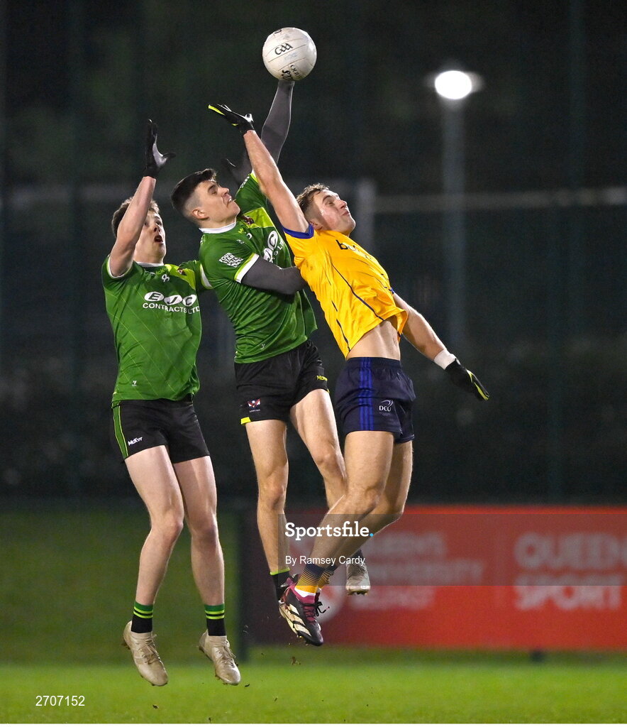9 January 2024; Rory Donnelly, centre, supported by Queens teammate Joe McDaid, competes for a high ball with Shane Walsh of DCU during the Electric Ireland Higher Education GAA Sigerson Cup Round 1 match between Queens University Belfast and DCU at The Dub at Queen’s Sport in Belfast. Photo by Ramsey Cardy/Sportsfile