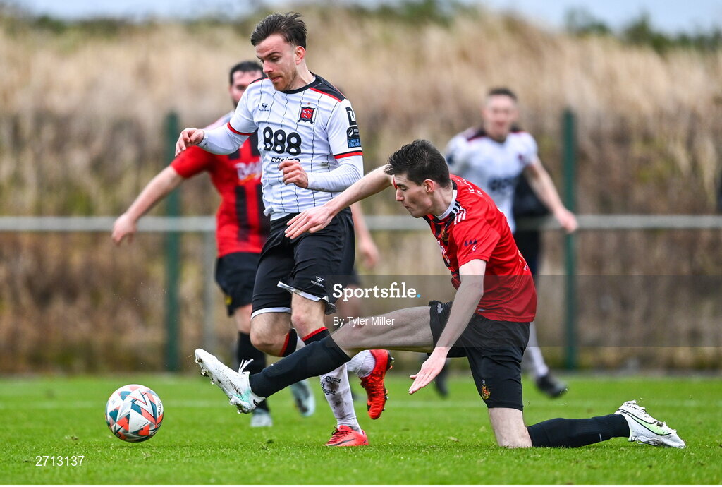 21 January 2024; Archie Davies of Dundalk on his way to scoring his side's third goal despite the efforts of Thomas Lynch of Malahide United AFC during the PTSB Leinster Senior Cup Group A match between Malahide United and Dundalk at Gannon Park in Malahide, Dublin. Photo by Tyler Miller/Sportsfile
