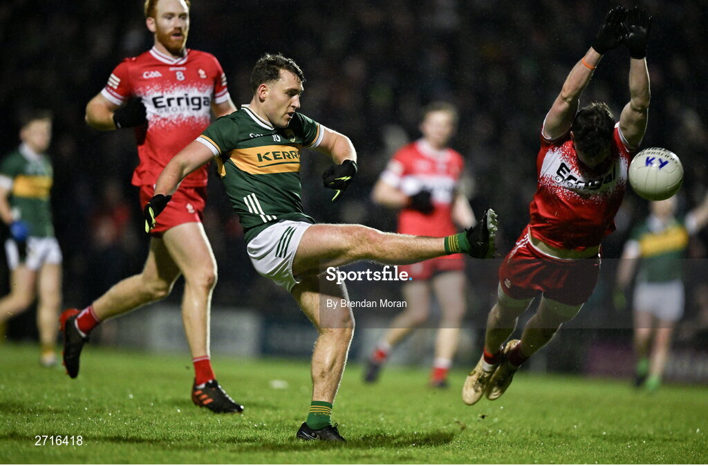 27 January 2024; Dara Moynihan of Kerry gets a shot in despite the efforts of Gareth McKinless of Derry during the Allianz Football League Division 1 match between Kerry and Derry at Austin Stack Park in Tralee, Kerry. Photo by Brendan Moran/Sportsfile