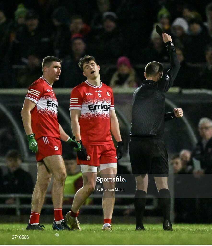 27 January 2024; Ciaran McFaul of Derry, left, is shown a black card by referee Joe McQuillan during the Allianz Football League Division 1 match between Kerry and Derry at Austin Stack Park in Tralee, Kerry. Photo by Brendan Moran/Sportsfile