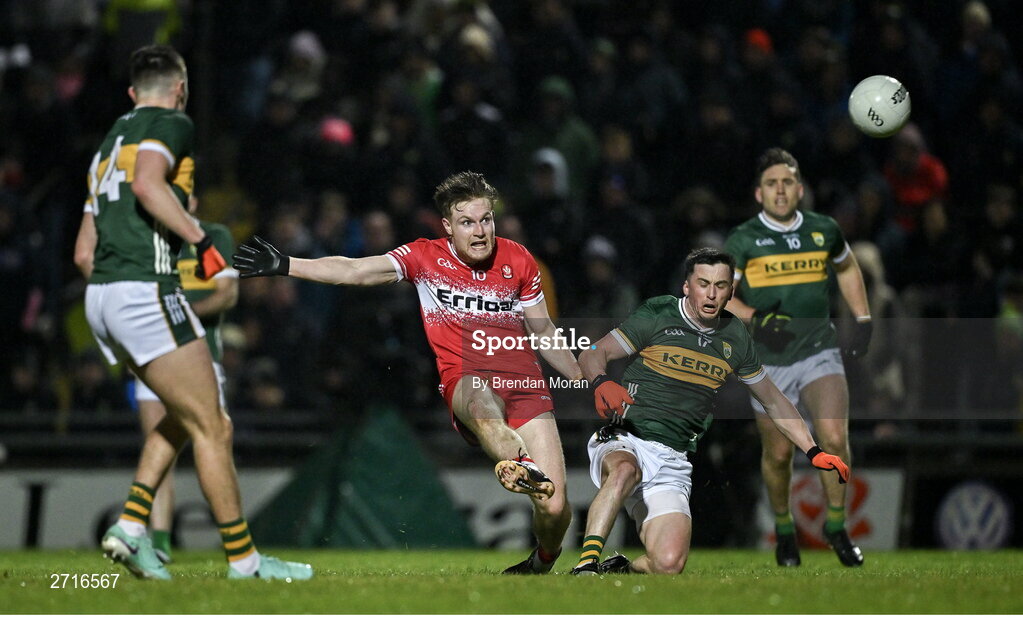 27 January 2024; Ethan Doherty of Derry kicks a score ahead of Paul Murphy of Kerry during the Allianz Football League Division 1 match between Kerry and Derry at Austin Stack Park in Tralee, Kerry. Photo by Brendan Moran/Sportsfile