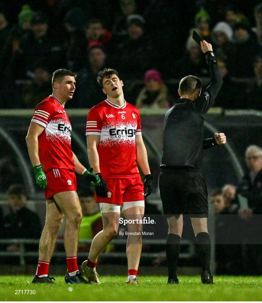 27 January 2024; Ciaran McFaul of Derry, left, is shown a black card by referee Joe McQuillan during the Allianz Football League Division 1 match between Kerry and Derry at Austin Stack Park in Tralee, Kerry. Photo by Brendan Moran/Sportsfile