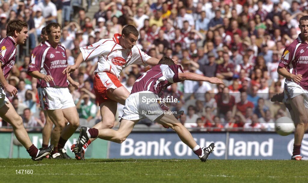 17 July 2004; Tyrone's Brian McGuigan scores the opening goal despite the attentions of Galway's Declan Meehan. Bank of Ireland Senior Football Championship Qualifier, Round 3, Tyrone v Galway, Croke Park, Dublin. Picture credit; Damien Eagers / SPORTSFILE