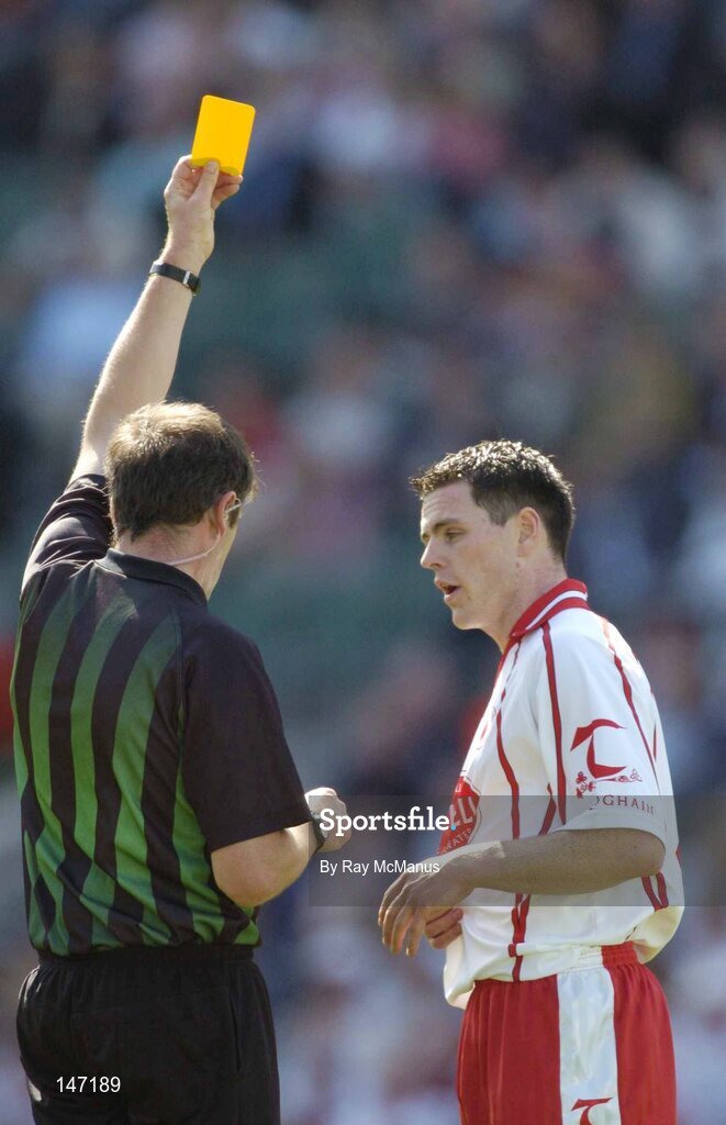 17 July 2004; Referee Michael Monahan shows the yellow card to Tyrone full-back Conor Gormley. Bank of Ireland Senior Football Championship Qualifier, Round 3, Tyrone v Galway, Croke Park, Dublin. Picture credit; Ray McManus / SPORTSFILE