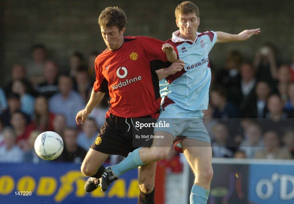 17 July 2004; Colin Heath, Manchester United XI, is tackled by John Andrews, Cobh Ramblers. Friendly game, Cobh Ramblers v Manchester United XI, Turners Cross, Cork. Picture credit; Matt Browne / SPORTSFILE