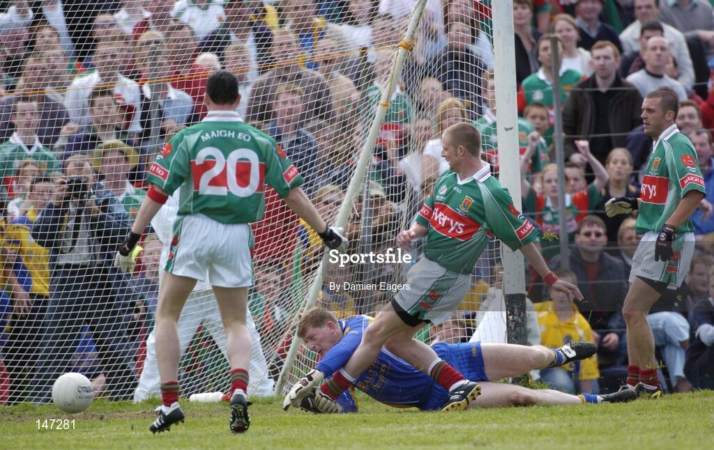 18 July 2004; Mayo's Austin O'Malley scores his sides second goal, watched by team-mates Declan Sweeney, (20) and Trevor Mortimer, despite the efforts of Roscommon goalkeeper Shane Curran. Bank of Ireland Connacht Senior Football Championship Final, Mayo v Roscommon, McHale Park, Castlebar, Co. Mayo. Picture credit; Damien Eagers / SPORTSFILE