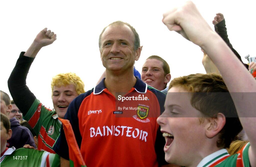 18 July 2004; John Maughan, Mayo manager, celebrates with young Mayo fans after victory over Roscommon. Bank of Ireland Connacht Senior Football Championship Final, Mayo v Roscommon, McHale Park, Castlebar, Co. Mayo. Picture credit; Pat Murphy / SPORTSFILE