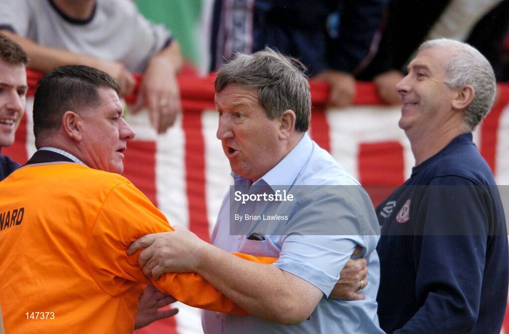 18 July 2004; Secretary of Shelbourne F.C. Ollie Byrne, centre, is restrained by a steward and Fred Davis, right, as he shouts in the direction of the referee. eircom league, Premier Division, Shelbourne v Drogheda United, Tolka Park, Dublin. Picture credit; Brian Lawless / SPORTSFILE