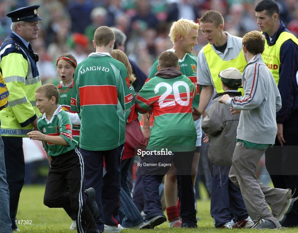 18 July 2004; Mayo supporters invade the pitch early to congradulate Mayo's Conor Mortimer as Gardai and stewarts try to clear the pitch. Bank of Ireland Connacht Senior Football Championship Final, Mayo v Roscommon, McHale Park, Castlebar, Co. Mayo. Picture credit; Damien Eagers / SPORTSFILE