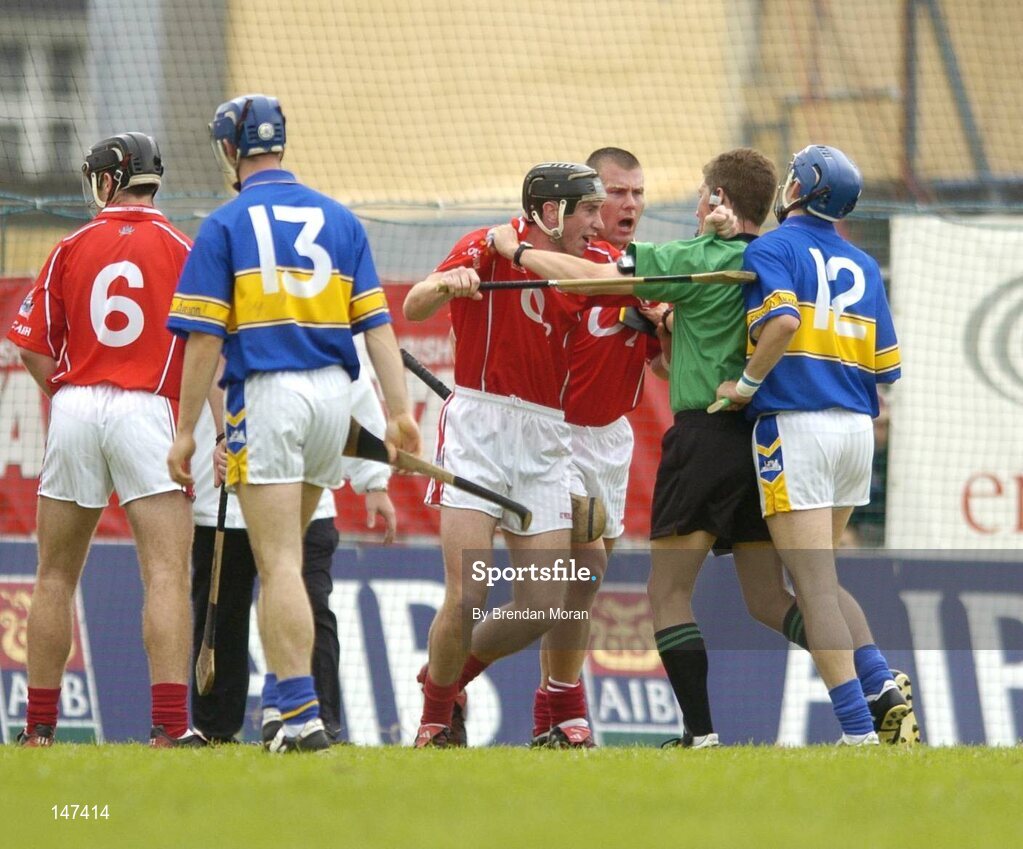 10 July 2004; Referee Barry Kelly has to restrain Cork's John Gardiner and Diarmuid O'Sullivan from Tipperary's Benny Dunne. Guinness Senior Hurling Championship Qualifier, Round 3, Cork v Tipperary, Fitzgerald Stadium, Killarney, Co. Kerry. Picture credit; Brendan Moran / SPORTSFILE