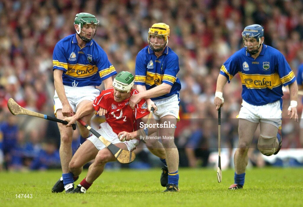10 July 2004; Niall McCarthy, Cork, in action against Declan Fanning, left, Eamonn Corcoran and Martin Maher, Tipperary. Guinness Senior Hurling Championship Qualifier, Round 3, Cork v Tipperary, Fitzgerald Stadium, Killarney, Co. Kerry. Picture credit; Brendan Moran / SPORTSFILE