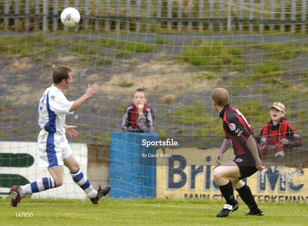 20 July 2004; Sean Francis, right, Longford Town, scores his sides first  goal desipe the challange from Finn Harps's Jonathan Minnock. eircom League Cup Semi-Final, Finn Harps v Longford Town, Finn Park, Ballybofey, Co. Donegal. Picture credit; David Maher / SPORTSFILE