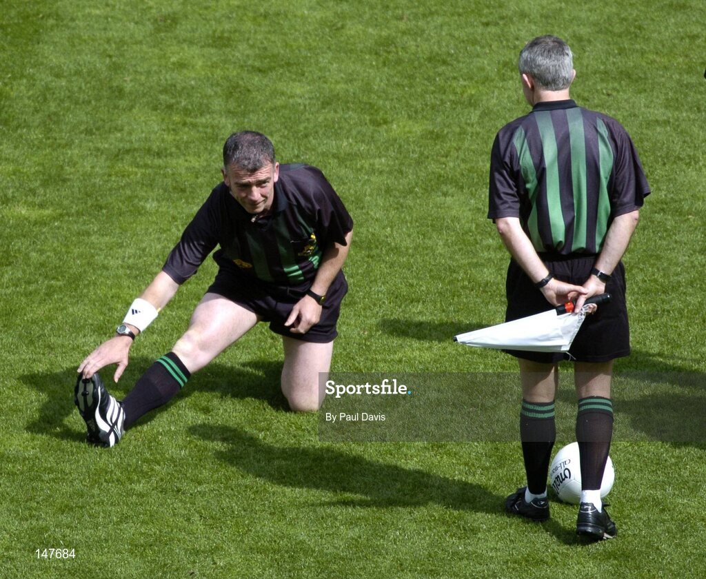 18 July 2004; Referee Pat McEnaney stretches before the game while chatting with linesman Paul Finnegan, right. Bank of Ireland Leinster Senior Football Championship Final, Laois v Westmeath, Croke Park, Dublin. Picture credit; Ray McManus / SPORTSFILE