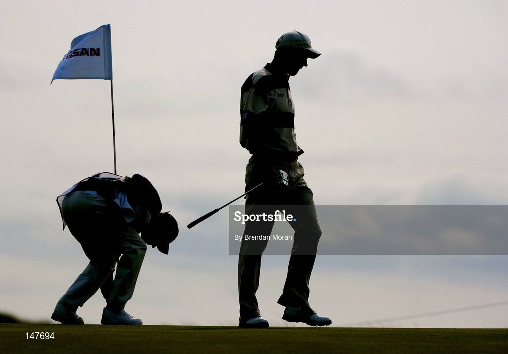 21 July 2004; Padraig Harrington leaves the 4th green as caddie Ronan Flood puts back the flag. Nissan Irish Open Pro Am, County Louth Golf Club, Baltray, Co. Louth. Picture credit; Brendan Moran / SPORTSFILE