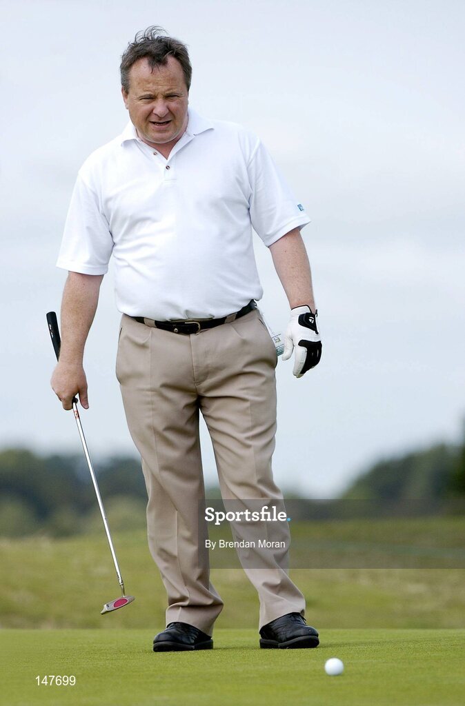 21 July 2004; Dublin football manager Tommy Lyons checks his line on the 7th green. Nissan Irish Open Pro Am, County Louth Golf Club, Baltray, Co. Louth. Picture credit; Brendan Moran / SPORTSFILE