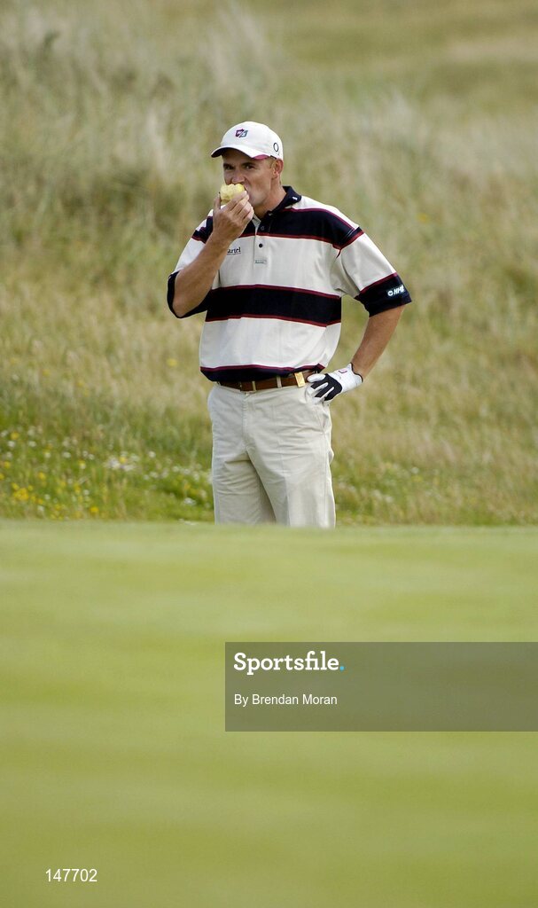 21 July 2004; Padraig Harrington enjoys an apple at the 7th green. Nissan Irish Open Pro Am, County Louth Golf Club, Baltray, Co. Louth. Picture credit; Brendan Moran / SPORTSFILE