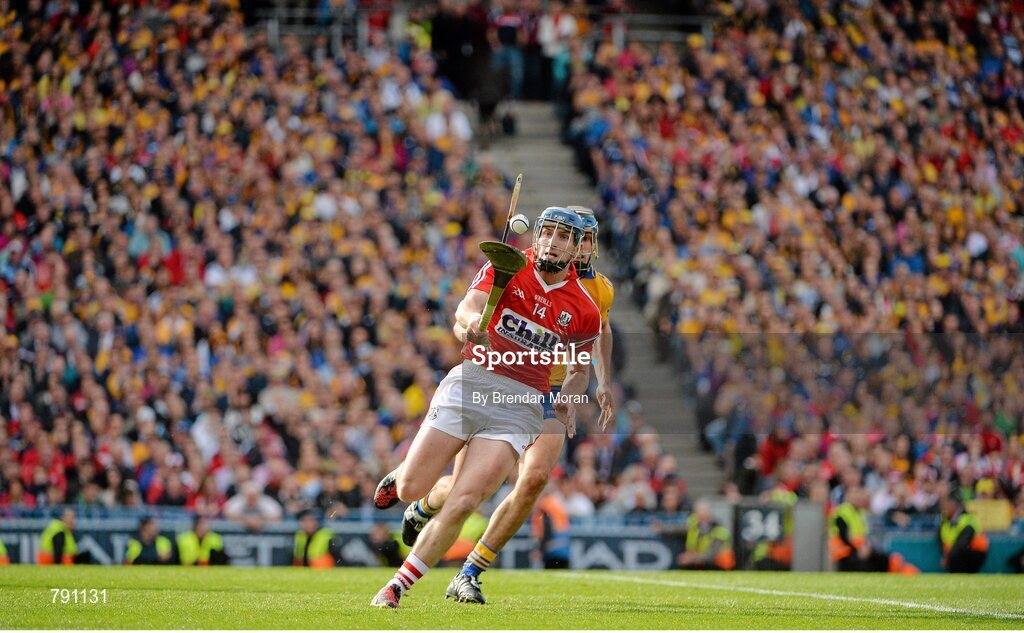 8 September 2013; Patrick Horgan, Cork, escapes the challenge of Brendan Bugler, Clare, on his way to scoring his side's last point of the game, which put them into the lead before Clare equalised to send the game to a replay. GAA Hurling All-Ireland Senior Championship Final, Cork v Clare, Croke Park, Dublin. Picture credit: Brendan Moran / SPORTSFILE