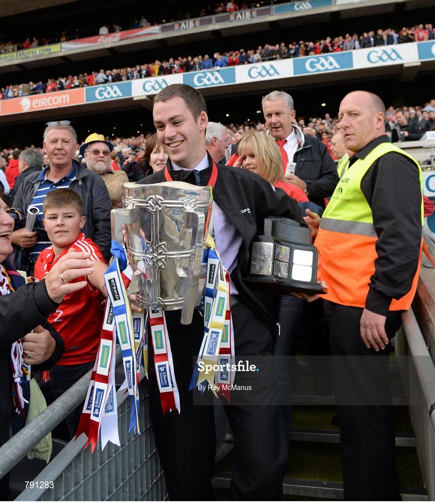 8 September 2013; Ard Comhairle stewart Colm Smith removes the Liam MacCarthy Cup to safe keeping after the game ended in a draw. GAA Hurling All-Ireland Senior Championship Final, Cork v Clare, Croke Park, Dublin. Picture credit: Ray McManus / SPORTSFILE