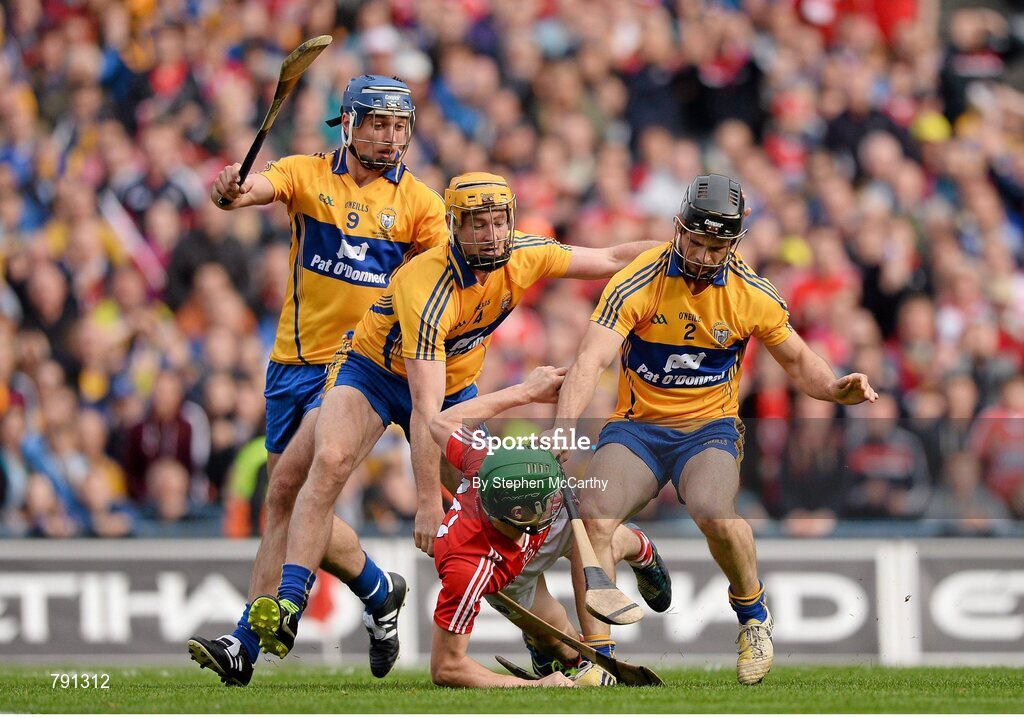 8 September 2013; Séamus Harnedy, Cork, is tackled by Clare players, from left, Conor Ryan, Cian Dillon and Brendan Bugler, resulting in a penalty. GAA Hurling All-Ireland Senior Championship Final, Cork v Clare, Croke Park, Dublin. Picture credit: Stephen McCarthy / SPORTSFILE