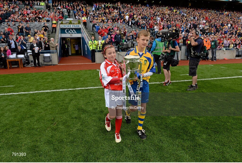 8 September 2013; Rebecca Barry, Gaelscoil An Ghoirt Alainn, Cork, and Eoghan Foudy, Ennis CBS Primary Schools, bring out the Liam MacCarthy Cup ahead of the game. GAA Hurling All-Ireland Senior Championship Final, Cork v Clare, Croke Park, Dublin. Picture credit: Stephen McCarthy / SPORTSFILE