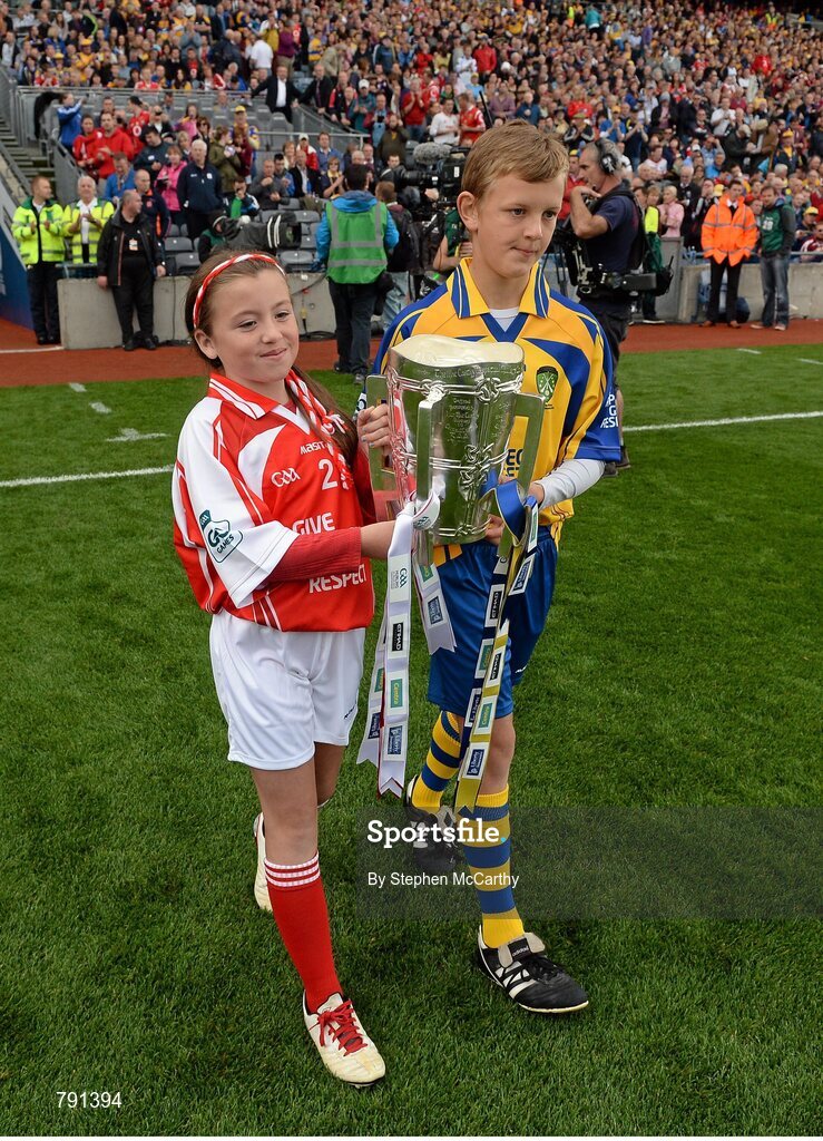 8 September 2013; Rebecca Barry, Gaelscoil An Ghoirt Alainn, Cork, and Eoghan Foudy, Ennis CBS Primary Schools, bring out the Liam MacCarthy Cup ahead of the game. GAA Hurling All-Ireland Senior Championship Final, Cork v Clare, Croke Park, Dublin. Picture credit: Stephen McCarthy / SPORTSFILE